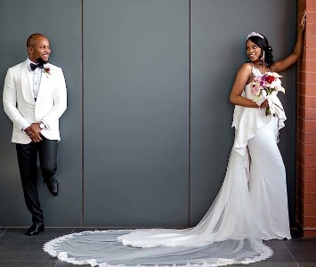 Bride and Groom Posing Against a Wall